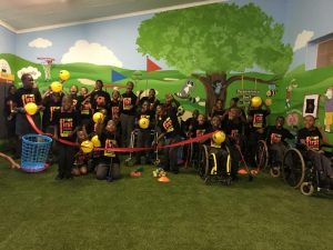 mural wall art assists first swing golf program helping children with disabilities social event